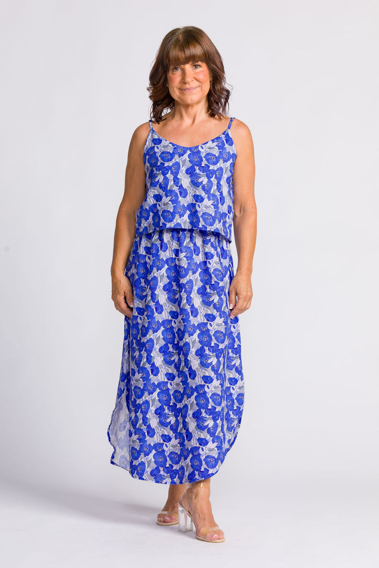 Woman wearing a blue floral dress on a white background