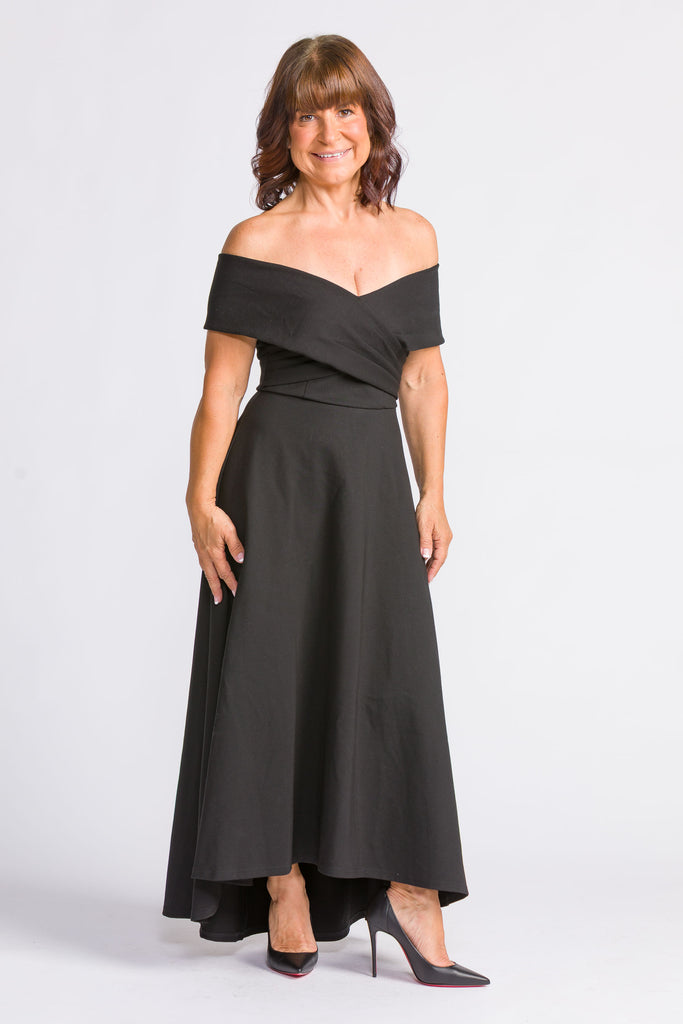 Jenny Evening Dress - Woman wearing a black off-shoulder dress on a white background