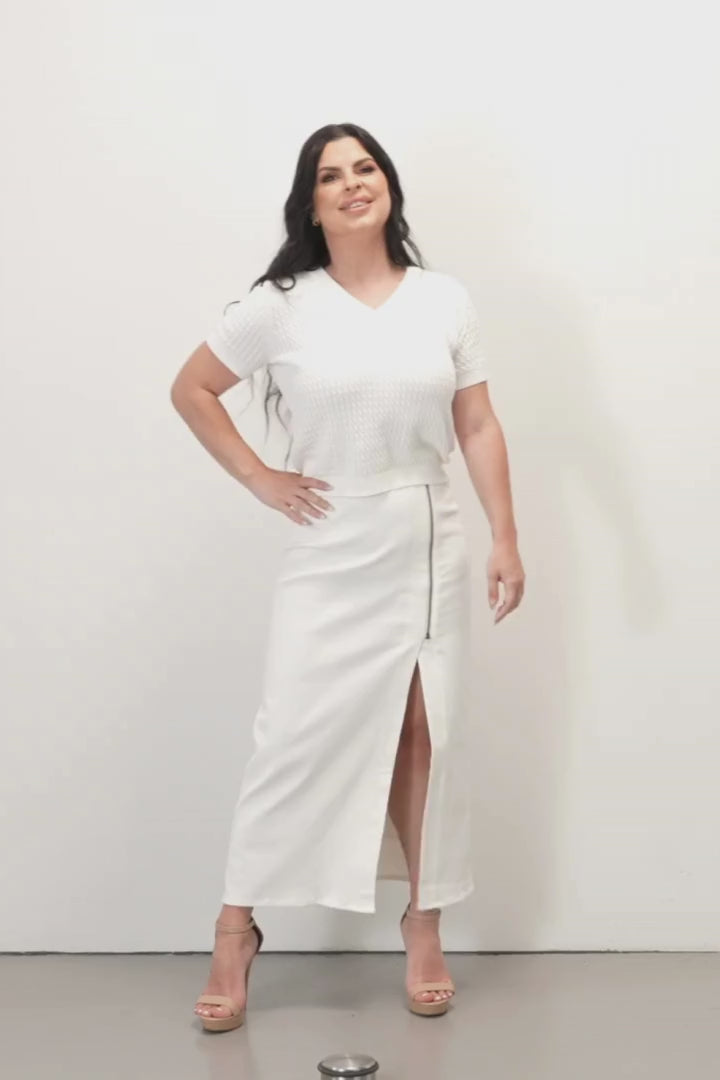 Nikita Long Zip Denim Skirt - White - Woman wearing a white knit top and a white denim skirt on a white background
