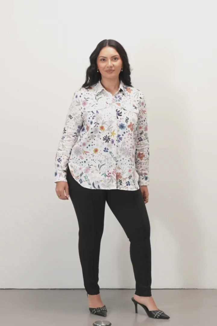 Hilary Long Sleeve Casual Shirt - Floral Print -  Woman wearing a colorful floral shirt against a plain background